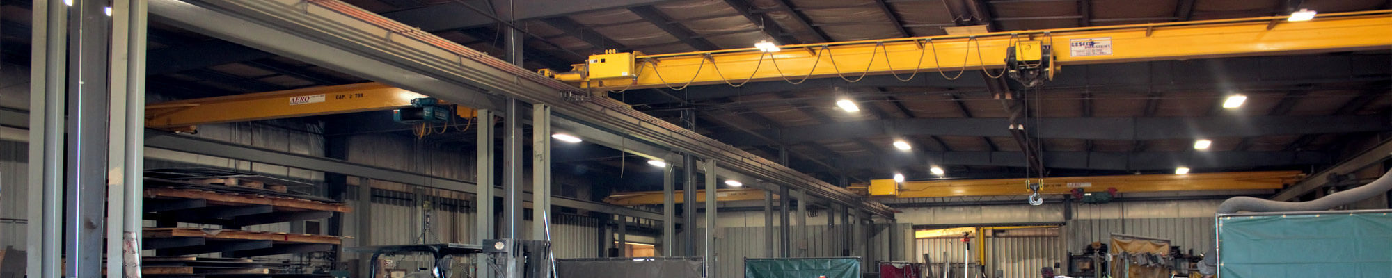 Yellow overhead cranes and manufacturing space inside Lee Industries of Little Falls