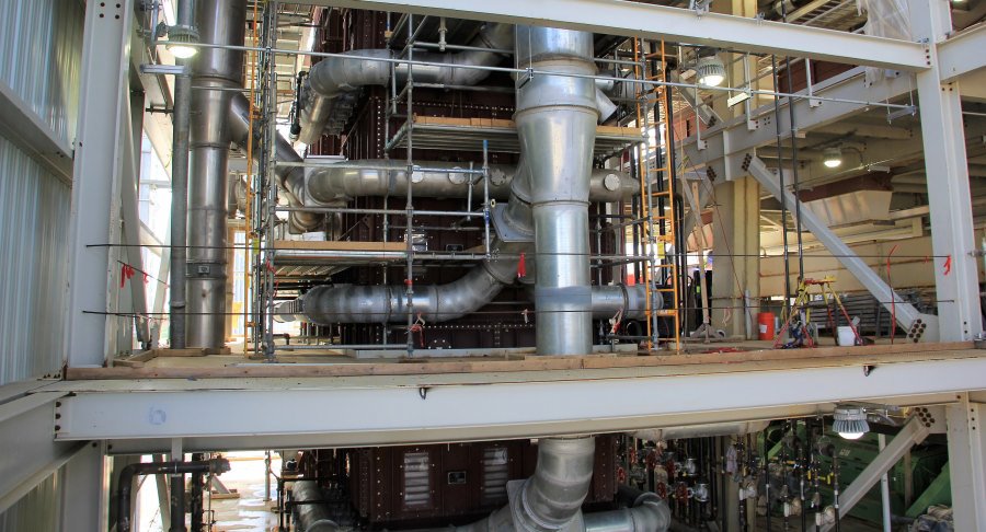 ductwork004 Large-scale industrial ductwork and piping systems being assembled within a steel structural frame at the Lee Industries facility in Little Falls, MN.