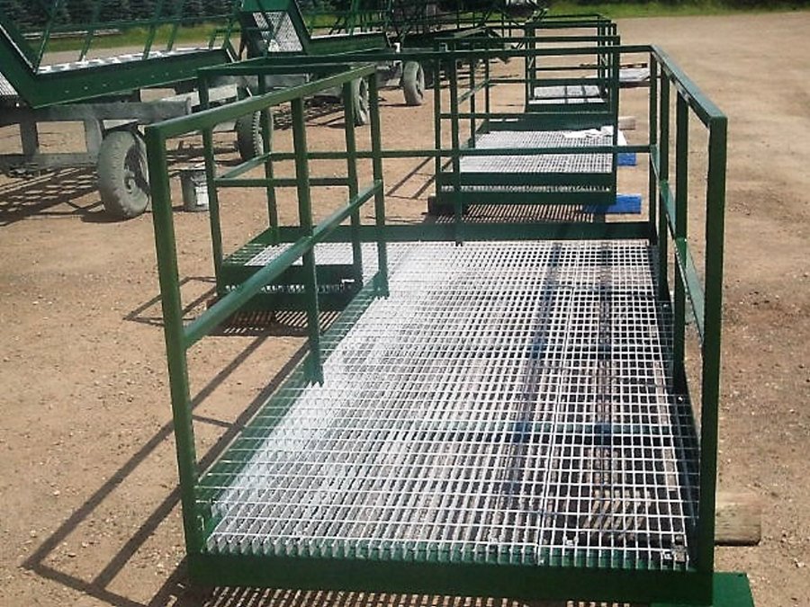 metalfab002 A custom-fabricated green metal safety platform with galvanized steel grating floor and secure handrails.